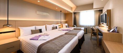 A hotel room with two beds, a desk, a chair, a television, and a large window with curtains.