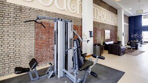 Une salle de sport avec un mur en briques et une grande enseigne blanche sur laquelle on peut lire « EXTÉRIEUR ».