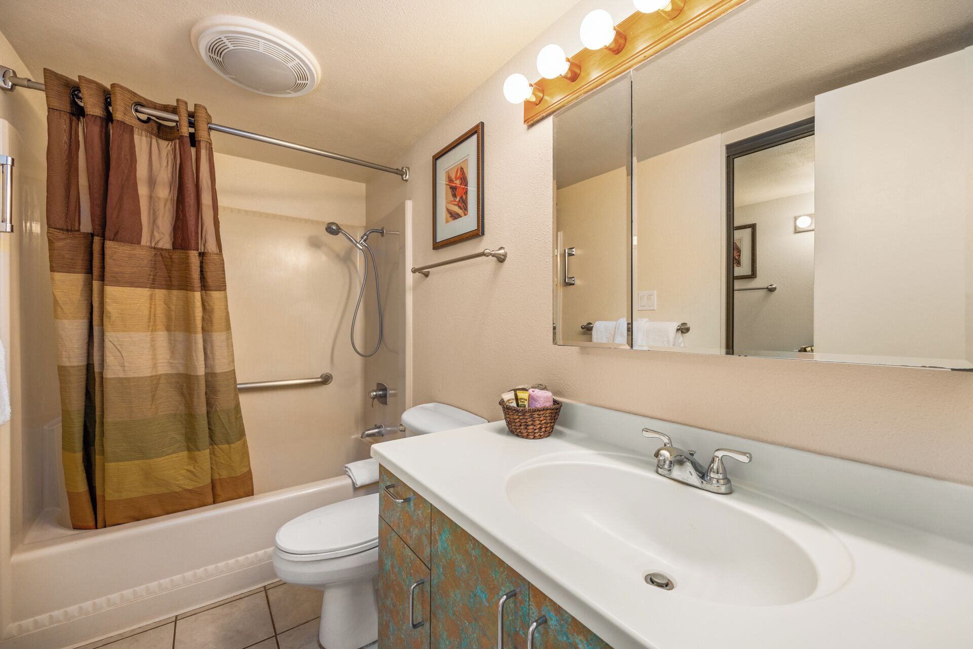 A bathroom with a bathtub, toilet, and sink.