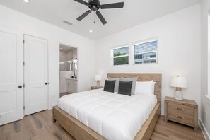 A bedroom with a bed, bedside tables, a ceiling fan, and a window with blinds. - New Home, Golf Cart, Walk To Beach! Private Pool! (Destin)