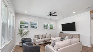 A modern living room with a sofa set, a coffee table, and a grey armchair.