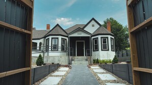A two-story house with a number '544' on the front door, a covered porch, and a pathway leading to the entrance.