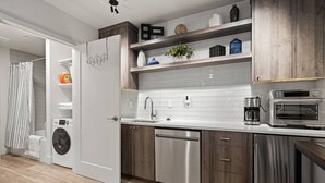 A modern kitchen with a built-in washer, dishwasher, and microwave. - Lake Oswego Quiet Ground Level Condo Private Entrance - Pet Friendly! (Lake Oswego)