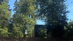 A parking area with a handicapped parking space and a sign indicating no parking. - Lake Oswego Quiet Ground Level Condo Private Entrance - Pet Friendly! (Lake Oswego)