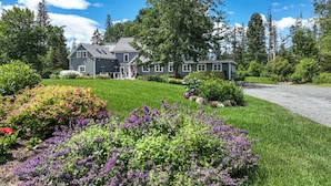 A two-story house with a well-maintained lawn and flower beds in front. - The Crocker House Country Inn (Rm 10) (Hancock)