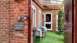 A brick house with a sign reading "Antelope House." - Farnham Haven: Unique Home with Courtyard (Farnham)