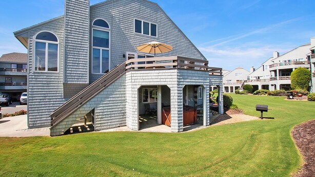 A two-story house with a covered patio and a staircase leading to the upper level. - Resort Amenities, Community Pools, Hot Tub-645, Cohasset II (Corolla)