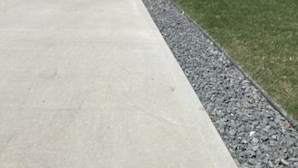 A two-story residential building with a garage, a front lawn, and a driveway. - Restful Haven (Winnipeg)
