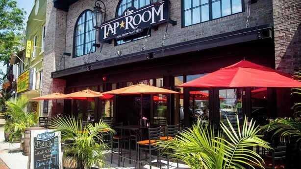 A restaurant with outdoor seating, a sign reading "Tap Room," and a chalkboard menu outside. - Comfort Suite in charming Bay Shore (Bay Shore)