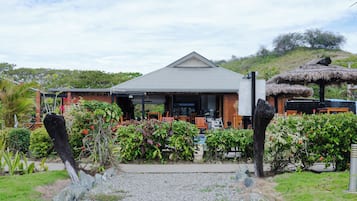 A building with a grey roof and a covered outdoor seating area.