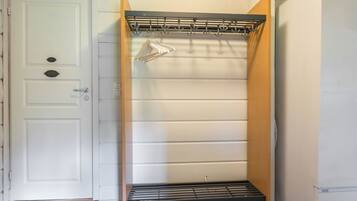 Una stanza con una porta bianca, un armadio bianco e un frigorifero bianco.