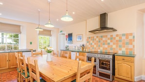 A kitchen with wooden cabinets, a stove, and a tiled backsplash.