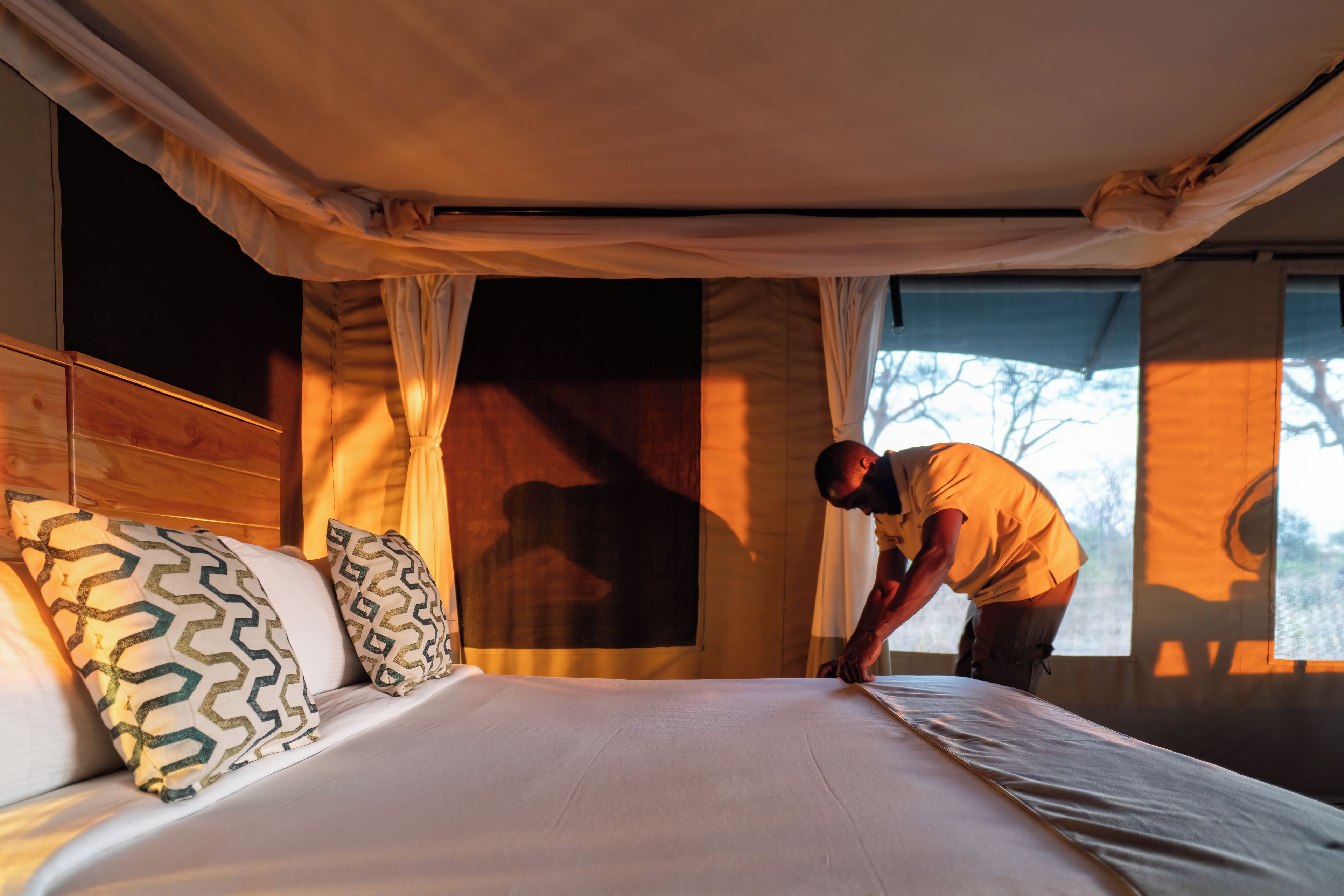 A room with a bed, a window, and curtains.
