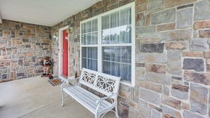 A stone exterior with a white bench and a red door. - 1 Mi to Colonial Beach Boardwalk! Cozy Family Home (Colonial Beach)