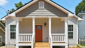A single-story house with a front porch, a red door, and a small front yard. - Heart of Cedartown | 0.3 miles from the Silver Comet Trail (Cedartown)