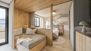 A modern bedroom with a wooden ceiling, a large bed with a fur throw, a nightstand with a lamp, and a view of a snowy landscape through a window. - Apartment Near Glacier ski Area (Kaprun)