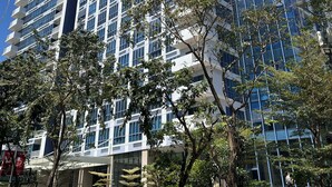 A high-rise building with multiple floors, large windows, and a modern architectural design.