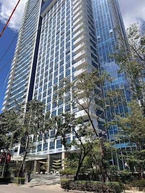 A high-rise building with multiple floors, large windows, and a modern architectural design.