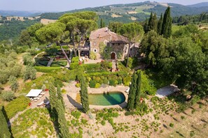 An aerial view of a villa with a garden, a swimming pool, and a stone pathway. - Villa in Badia A Passignano with 9 bedrooms sleeps 18 (Badia A Passignano)