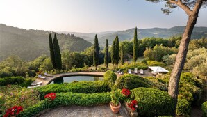 A landscaped garden with a pool, seating areas, and a view of the surrounding hills. - Villa in Badia A Passignano with 9 bedrooms sleeps 18 (Badia A Passignano)