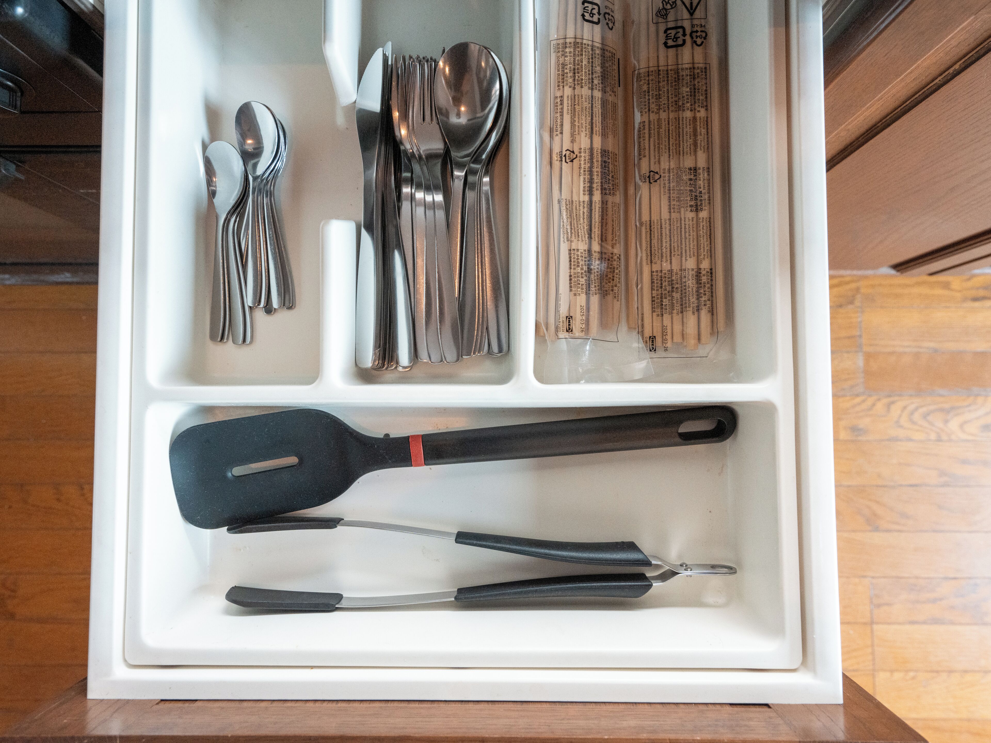 A drawer with utensils and kitchen tools.