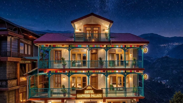 A multi-story hotel with balconies, a sign reading 'Hotel Ranveer Palace,' and a mountainous backdrop. - Hotel Ranveer Palace (Narkanda)
