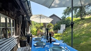 An outdoor dining area with a blue tablecloth, set for a meal. - Beautiful private villa for 6 guests with terrace (Altglashütten)