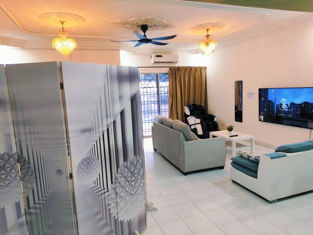 A modern living room with a sofa, a coffee table, a TV, and a decorative glass partition.