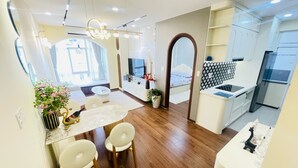 A modern interior with a dining area, kitchen, and living space. - Sky Garden 3 (Ho Chi Minh City)
