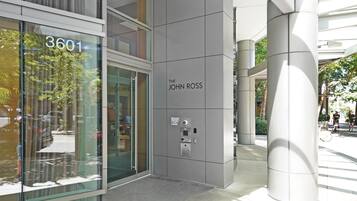 A modern building with a glass facade, a sign reading "3601", and a plaque that says "The John Ross".