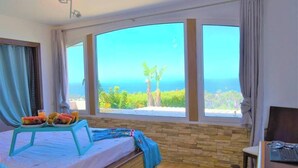 A room with a bed, a laptop, and a breakfast tray with fruits and juice. - Exclusive Golf Villa (Private Swimming Pool) Costa Adeje (Adeje)