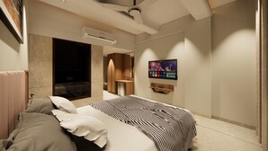 A modern hotel room with a large bed, a TV mounted on the wall, and a built-in seating area. - Hotel Status Inn (Ambernath)