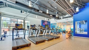 A gym with treadmills, exercise bikes, and weight machines. - Boulevard Stays Modern Tempe 1BR ASU Pool, Gym 08 (Tempe)
