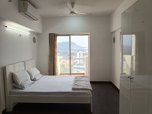Deluxe Apartment, Kitchen, Golf View | Iron/ironing board, free WiFi - Teesta Suites Lodha Belmondo Golf Resort (Mawal)