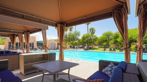 An outdoor pool area with lounge seating and a covered patio. - Amazing Desert Views! Tucson Casita on Golf Course (Tucson)