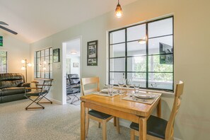 A dining area with a wooden table, chairs, and a large window. - 3 Mi to Dtwn Fort Myers: Apt w/ Outdoor Space (Fort Myers)