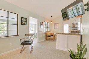 A spacious kitchen with a dining area, a large window, and a television mounted on the wall. - 3 Mi to Dtwn Fort Myers: Apt w/ Outdoor Space (Fort Myers)