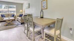 A dining area with a wooden table and chairs, a sofa set, and a lamp. - 2 Mi to State Park: Dog-friendly Niceville Home (Niceville)