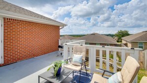 A patio with a white railing, a table, and a chair. - 3 Mi to Escambia Bay: Home w/ Deck & Private Yard! (Milton)