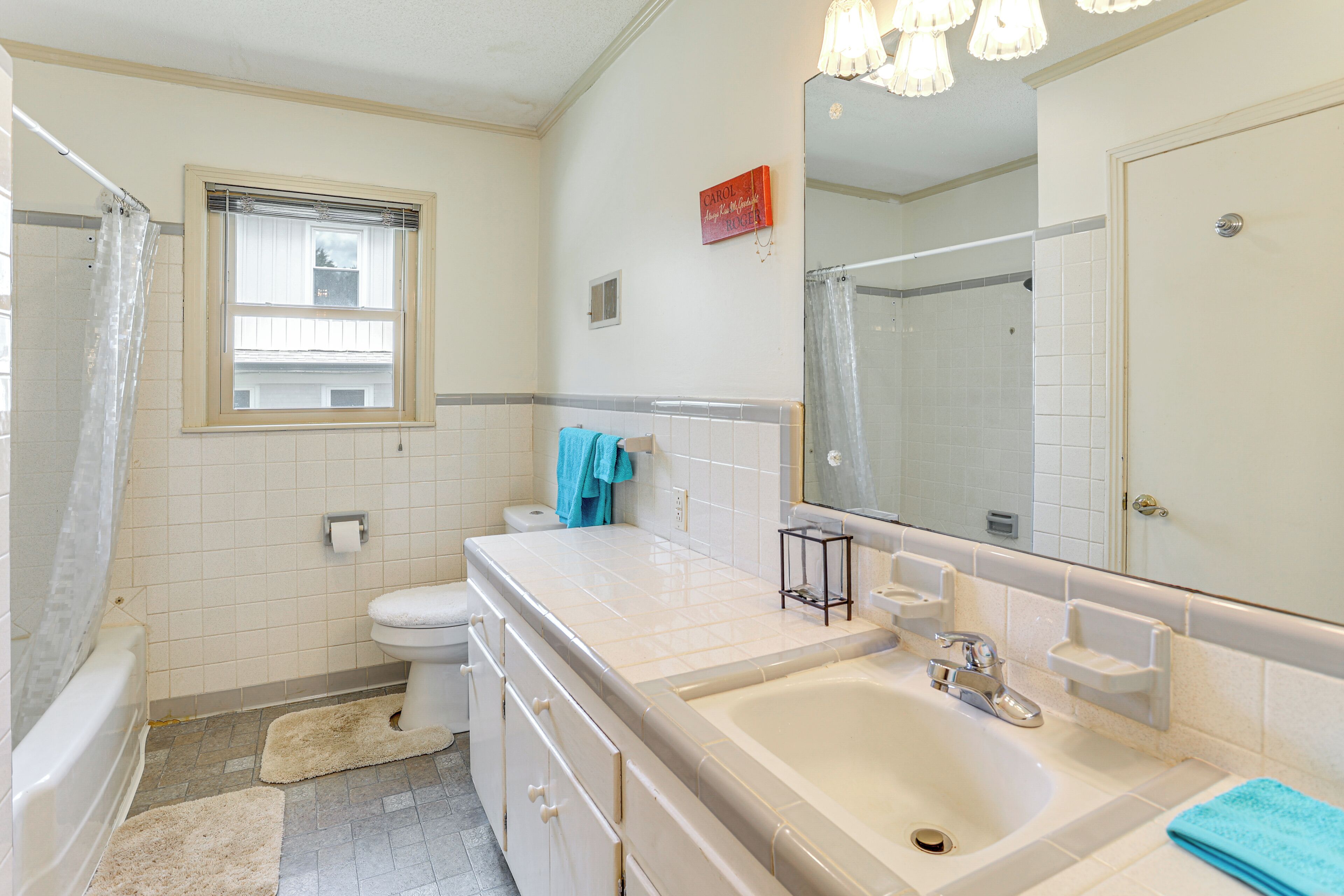 A bathroom with a bathtub, toilet, and sink.
