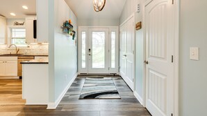 A hallway with a wooden floor, white doors, and a chandelier. - 4 Mi to Dtwn: Ohio River Valley Home w/ Deck! (Aurora)