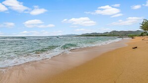 A beach with clear skies and gentle waves.