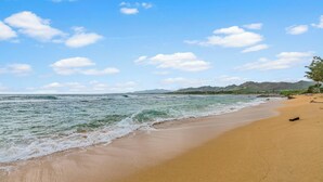 A beach with clear skies and gentle waves.