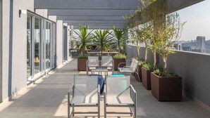 A rooftop terrace with seating, planters, and a view of the city. - Apartment with 1 parking space - near the US Consulate! (Vila Sao Francisco (Zona Sul) São Paulo)