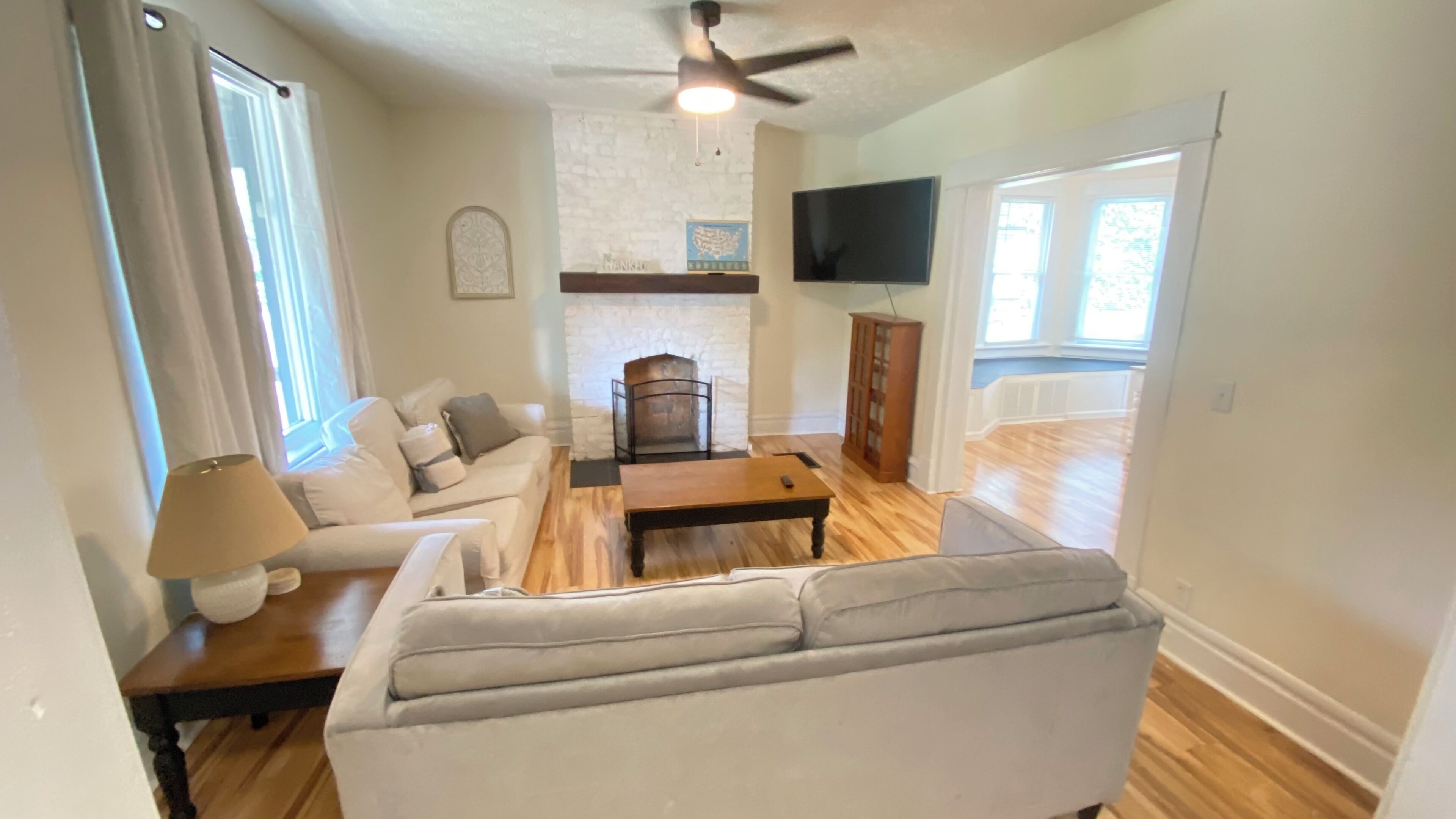 A living room with a sofa, coffee table, and fireplace.