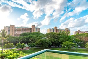 A residential building complex with multiple apartment buildings, surrounded by lush greenery and a clear sky. - Honua Kai | Ocean View 5 BR, Sleeps 14 | Car Incl. w/ 6+ Nights | HKK ML-1403 by KBM (Lahaina)