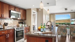 A modern kitchen with wooden cabinets, stainless steel appliances, and a large island.