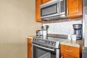 A kitchen with a Bosch microwave, a coffee maker, and a toaster.