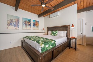 A bedroom with a wooden bed, a ceiling fan, and three wall-mounted air conditioning units. - Napili Point | Oceanfront 3 BR, Sleeps 8 | Car Incl. w/ 6+ Nights | NAP ML-1541 by KBM (Lahaina)