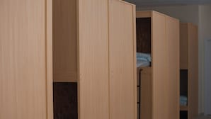A room with wooden bunk beds and a wardrobe. - Rox Madrid Shared room (Madrid)